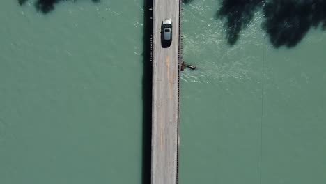 Bird's-Eye-View-of-a-Car-Driving-Over-a-Bridge