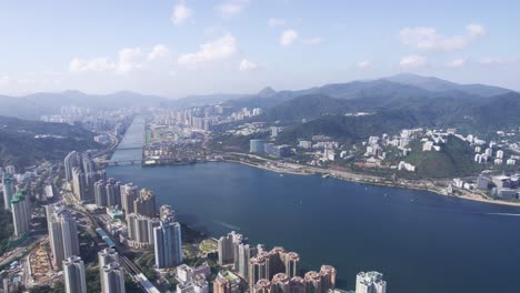 High-skyscrapers-at-Vista-Paradiso-and-big-appartments-in-the-background-between-the-mountains-of-Tai-Po-Kau-and-Shing-mun-river-on-a-cloudy-and-sunny-day