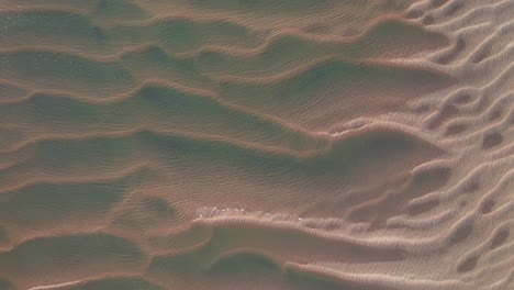 Transparent-texture-of-relief-from-beach-sand-and-sea-water