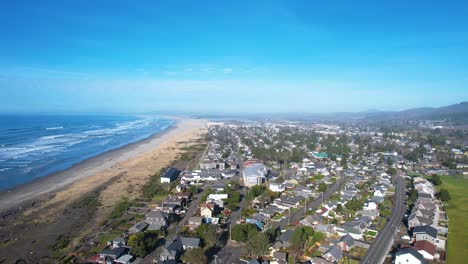 4K-aerial-drone-shot-descending-downwards-over-Seaside,-Oregon-beach-houses-on-a-sunny-day