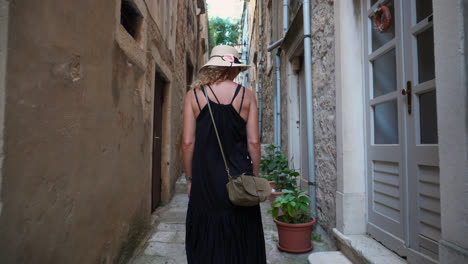 Beautiful-Woman-In-Dress-Walking-On-Narrow-Street-Of-Ancient-Town---tracking