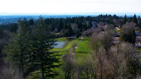 4K-aerial-drone-shot-gliding-into-a-public-park-in-Portland,-Oregon
