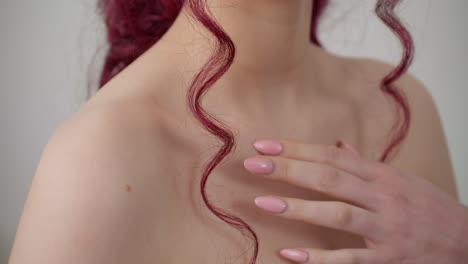 Close-up-of-young-sexy-woman-gently-touching-her-smooth-and-nourished-skin-of-neckline-with-her-elegant-hands
