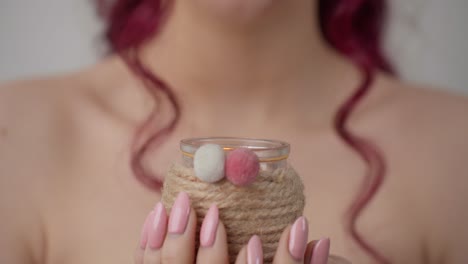 Unrecognizable-topless-girl-holding-scented-candle-in-glass-jar
