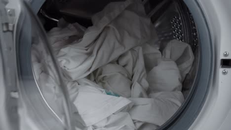 Hand-opening-washing-machine-with-sheet-putting-laundry-detergent