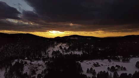 Drone-shot-of-sunset-over-snowy-mountain