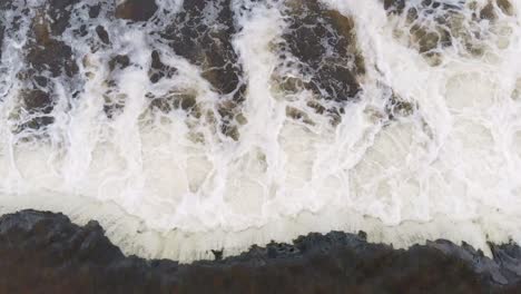 Top-down-aerial-view-of-Bream-fishes-trying-to-jump-upstream-against-waterfall