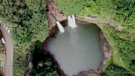 Steady-drone-shot-high-above-Wailua-Falls-waterfall-and-rainforest-in-Kauai,-Hawaii