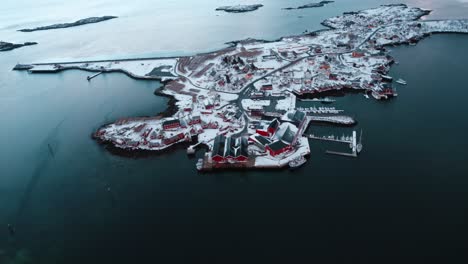 Flying-drone-over-Reine-in-the-Lofoten-Islands,-Norway-while-covered-in-snow