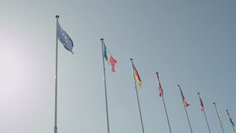 European-Union-flags-hoisted-and-waving-in-wind-against-blue-sky
