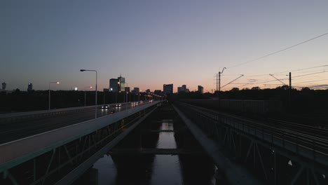 Camera-reverses-through-the-middle-of-Gdanski-bridge-with-an-evening-light-traffic-background-of-warsaw's-modern-center