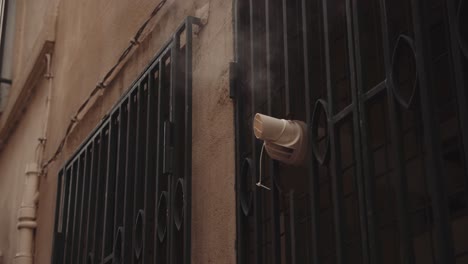 Smoke-Tube-Ventilation-Outside-A-Building's-Grilled-Window