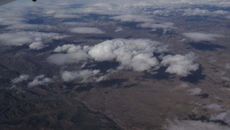 Aerial-view-of-America-above-the-clouds-out-of-plane-window-4k