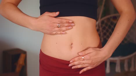 Front-view-caucasian-woman-hands-massaging-her-own-stomach