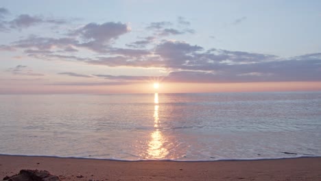Bright-sunset-reflects-in-Mediterranean-sea-water-near-Cyprus-island-coastline,-static-cinematic-view
