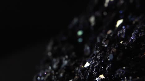 Closeup-of-Purple-Mineral-in-Dark-Room,-crystallic-parts