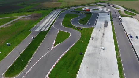 Aerial-footage-of-the-Titi-Aur-racetrack-with-cars-speeding-around-the-curves