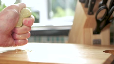 Slow-motion-shot-of-the-juice-being-squeezed-out-of-a-lemon