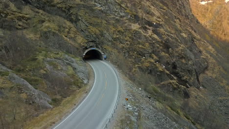 Aerial-View-Flying-Towards-the-Entrance-of-a-Tunnel-Cutting-Through-a-Mountain-in-Norway