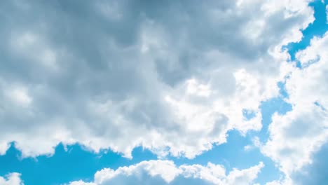 Time-lapse-clip-of-white-fluffy-clouds-over-blue-sky