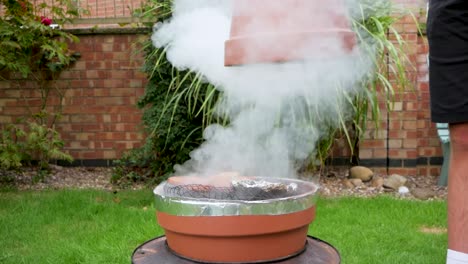 Lifting-off-the-homemade-smoker-to-reveal-the-contents