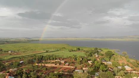 Aerial-shot-of-rural-villages-with-a-rainbow-in-the-background-in-Africa