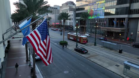 Downtown-New-Orleans-Canal-St-view-with-USA-and-Louisiana-flags-and-street-car