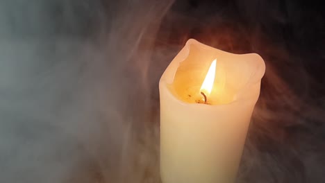 haunted-theme-and-scary-white-smoke-fog-rolling-over-an-old-oak-table-with-a-dark-background-over-and-past-a-burning-candle-flame