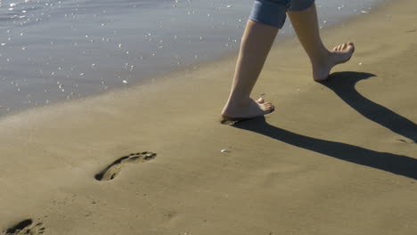 Female-legs-walk-on-a-beach