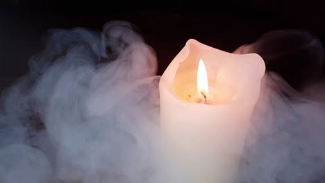 haunted-theme-and-scary-white-smoke-fog-rolling-over-an-old-oak-table-with-a-dark-background-over-and-past-a-burning-candle-flame