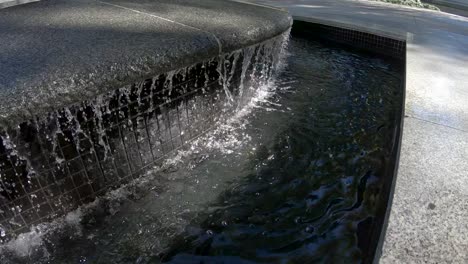 Water-running-a-dripping-in-slow-motion-from-a-man-made-fountain
