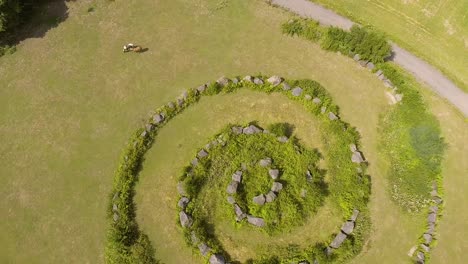 Flight-up-above-a-mysterious-stone-circle-on-a-field