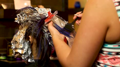 Beautician-Applies-purple-hair-dye