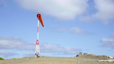 A-windsock-blowing-next-to-an-airport