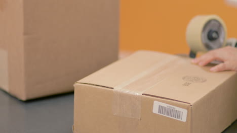 Taping-and-sealing-a-package-box-for-shippment
