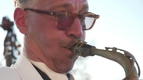 close-up-of-musician-playing-sax-outdoors
