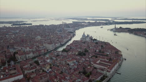 Wide-aerial-descending-shot-of-San-Marco-area-from-above-at-dusk,-Venice,-Italy