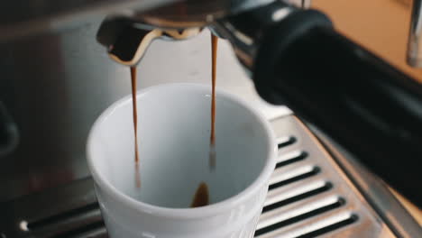 Coffee-gently-flowing-into-Espresso-Cup-top-view-in-slow-motion