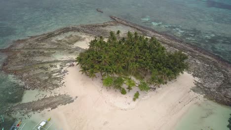 Aerial-shot-pedestal-up-panning-down-and-left-on-beautiful-Guyam-Island,-Siargao,-the-Philippines