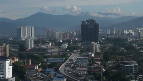 Top-view-of-the-Kuala-Lumpur's-downtown-with-mountains-in-the-background