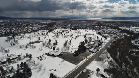 Slow-pan-drone-shot-over-city-covered-in-snow