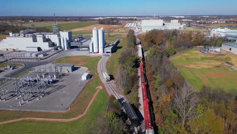 Aerial,-train-rail-leading-to-industrial-factory