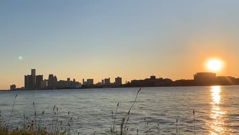 Amazing-nature-and-sunset-time-lapse-by-the-river-and-sun-sets-behind-the-buildings