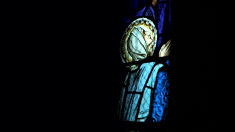 Panning-shot-of-virgin-Mary-vitrage-in-old-church