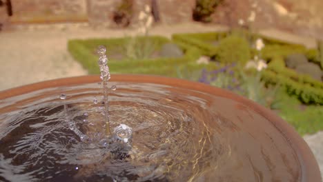 Small-water-fountain-in-secret-garden.-Focus-Pulling