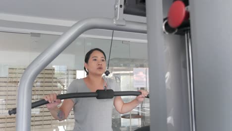 Premium Photo  Young woman working out on lat pulldown machine at gym