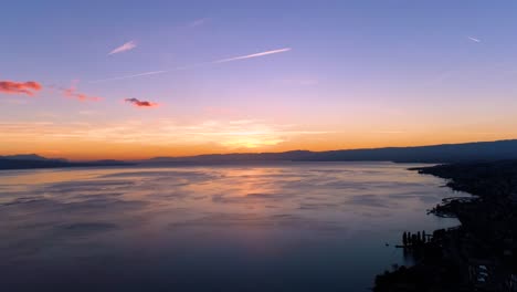 Flying-high-above-Lake-Léman,-beautiful-sunset-colors-Lavaux---Vaud,-Switzerland