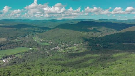Drone-descent-into-beautiful-valley-with-town-below-in-the-Catskill-Mountains-of-New-York-State