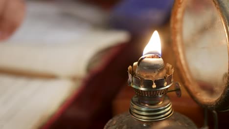 Close-up-of-using-a-match-to-light-an-old-oil-lamp