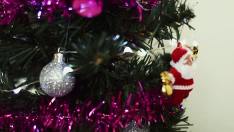 Close-up-video-shot-of-Christmas-tree-decorations-and-Santa-Claus-in-miniature